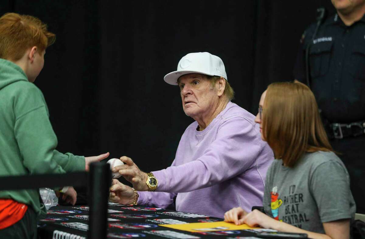 Pete Rose signs autographs for fans during the third annual Fiterman Sports Autograph Show of Texas at the Pasadena Fairgrounds Convention Center on Sunday, Jan. 30, 2022 in Pasadena.