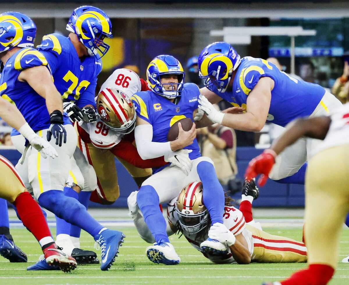 Los Angeles Rams quarterback Matthew Stafford (9) is sacked by San Francisco 49ers defensive end Arden Key (98) and San Francisco 49ers middle linebacker Fred Warner (54) in the second half on Jan. 9, 2022 at SoFi Stadium in Inglewood, California.(Gina Ferazzi/Los Angeles Times/TNS)