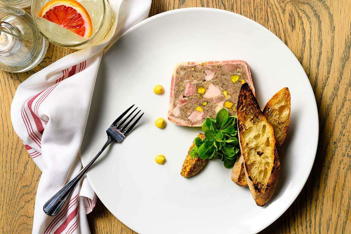Pork and duck pâté with pickled vegetables, Dijon mustard and mache, served with a toasted baguette.