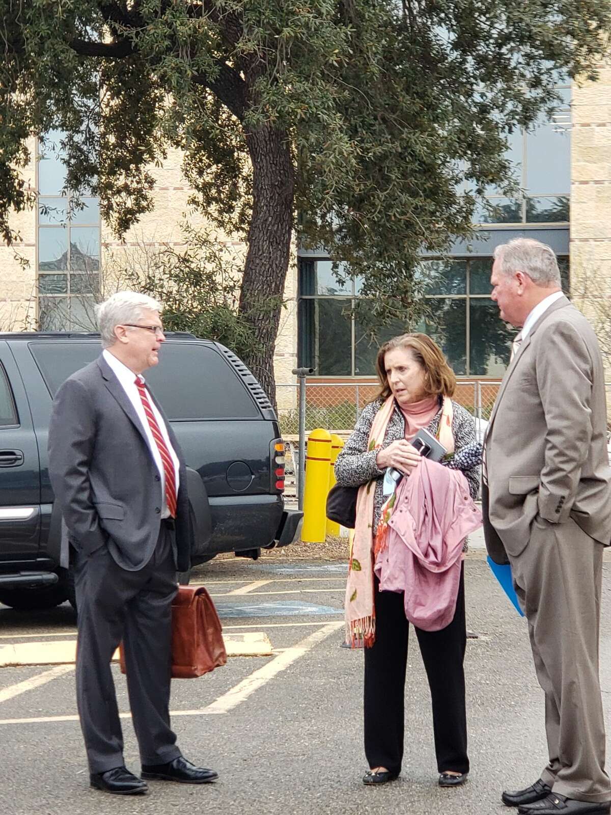 Former FedEx pilot Robert Steven Powell, far right, and his wife, Peggy, talk with Powell's lawyer, Michael Gross, near the federal courthouse in San Antonio after Powell was sentenced to 51 months in prison for tax evasion.