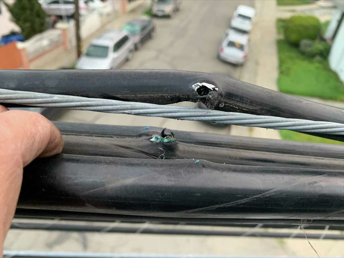 A photo of a damaged Comcast cable that the company suspects was hit by gunfire in Oakland, Calif. The damage wire knocked out Comcast service to thousands in Oakland, but a spokesperson for the company later said that cable and internet services had been restored.