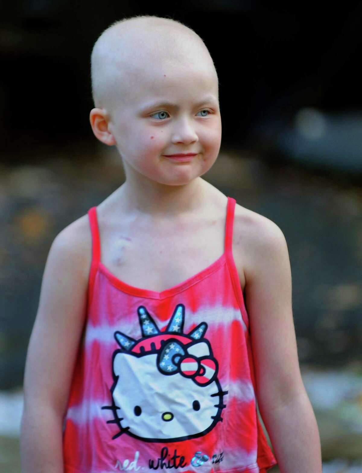 Cancer survivor Mia McCaffrey, 6, plays in the backyard with her friends at her home on Cottage Street in Trumbull, Conn. on Wednesday Nov. 2, 2016. Mia has been featured in a viral music video called "Fighter" by musician Taylor Tote, which is about cancer survivors.