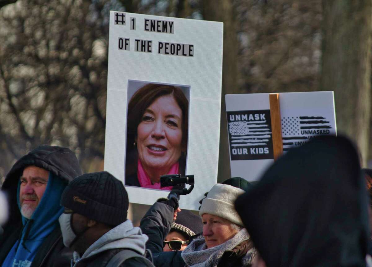 A person holds a sign with a photo of Governor Kathy Hochul on it during a rally for candidate for governor, Congressman Lee Zeldin, outside the Capitol on Monday, Jan. 31, 2022, in Albany, N.Y. Congressman Zeldin held the rally to talk about fighting to end the mask mandate in the State and to let parents make the choice if their children should wear a mask or not.