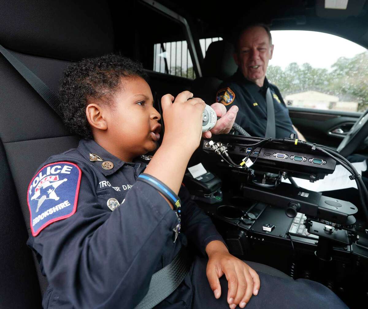 Devarjae “DJ” Daniel answers his first call as an honorary member of the Montgomery County Sheriff’s Office, Monday, Jan. 31, 2022, Conroe. Daniel is battling a terminal brain and spine cancer and is working on a goal of being sworn in by 100 law enforcement agencies.