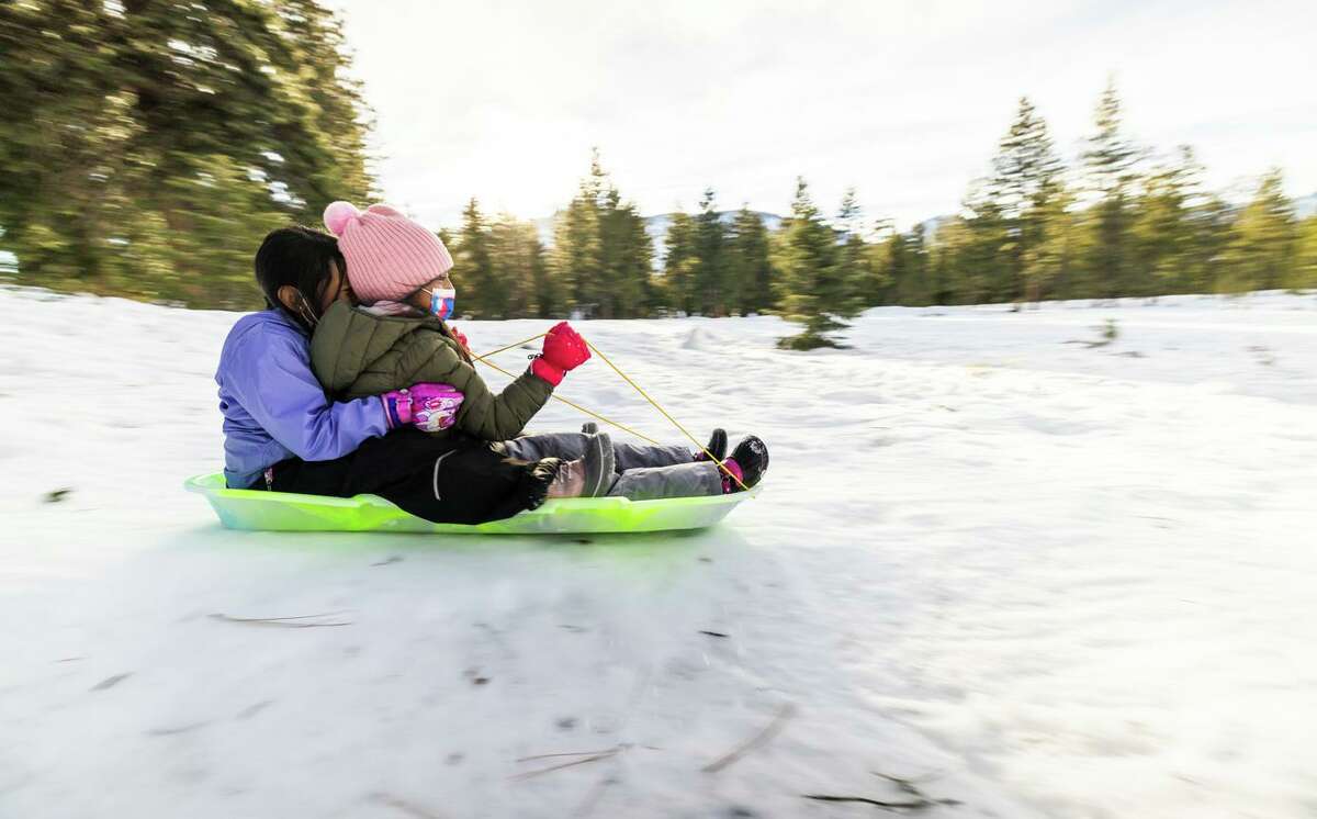 Dariana Santos and Stephanie Aguilar enjoy some sledding near the Washoe Tribal Cultural Center Sno-Park in South Lake Tahoe early this month.