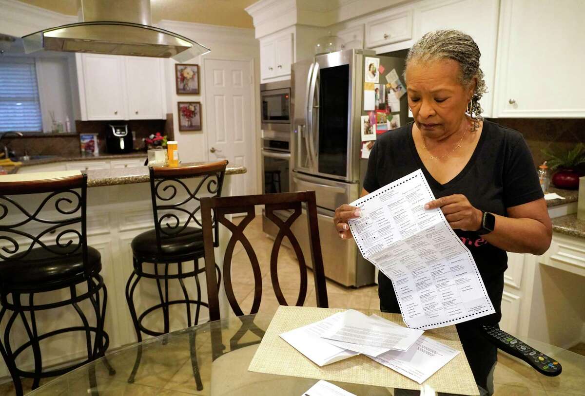 Pam Gaskin opens her mail ballot she received today after multiple requests were rejected earlier this year shown at her home Monday, Jan. 31, 2022 in Missouri City.