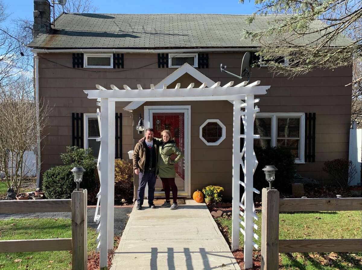 Molly Pope and her fiancé Andrew Krucoff outside their Athens home in 2020, upon getting the keys. Little did they know what was lurking in the walls.
