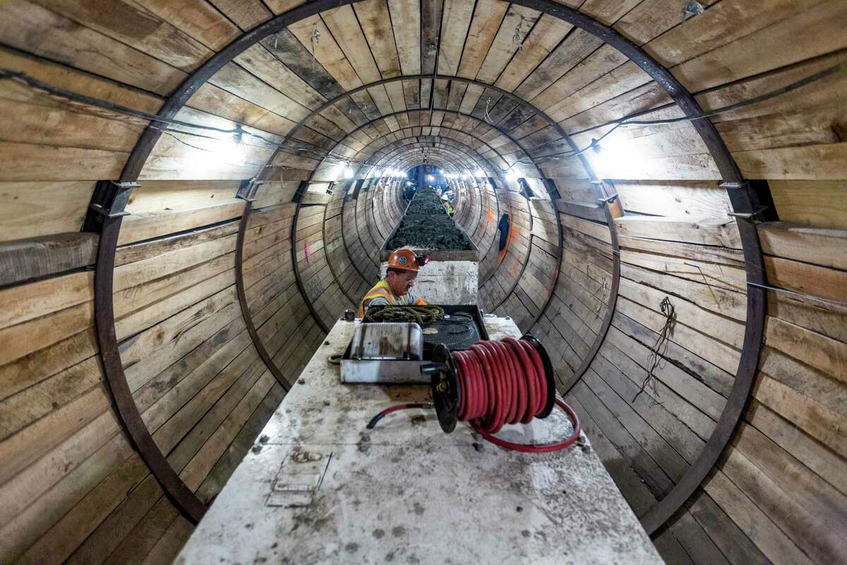 Loci operator Martin Rios waits to move his locomotive at the construction site of the San Antonio Water System’s W-6 sewer pipe project. The locomotive moves material between the head of the tunnel boring machine and the shaft where the material is hoisted to the surface for removal.