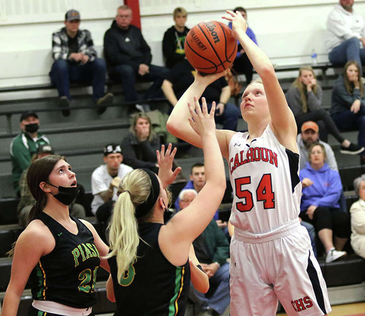 Calhoun's Audrey Gilman (54) puts up a shot over Southwestern's Addie Green and Tristyn Ditterline (left) on Monday night at Ringhausen Gym in Hardin.