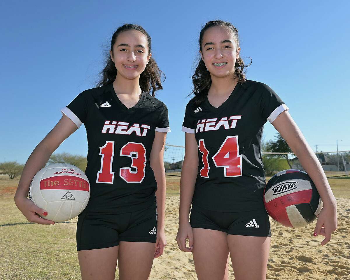 Rogerio twins, Eva, left, and Olivia pose in their Heat Volleyball Academy uniforms. The girls participate in volleyball, basketball and softball travel teams.