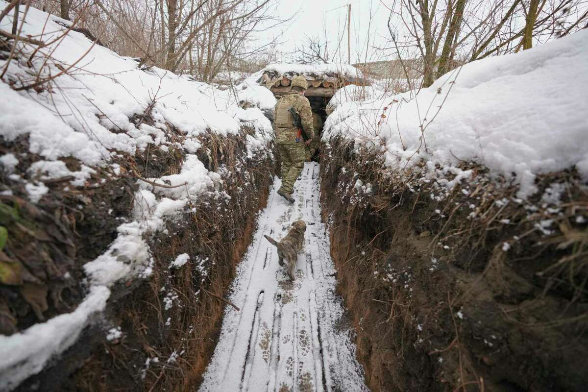 A Ukrainian serviceman walks through a trench in eastern Ukraine Tuesday.
