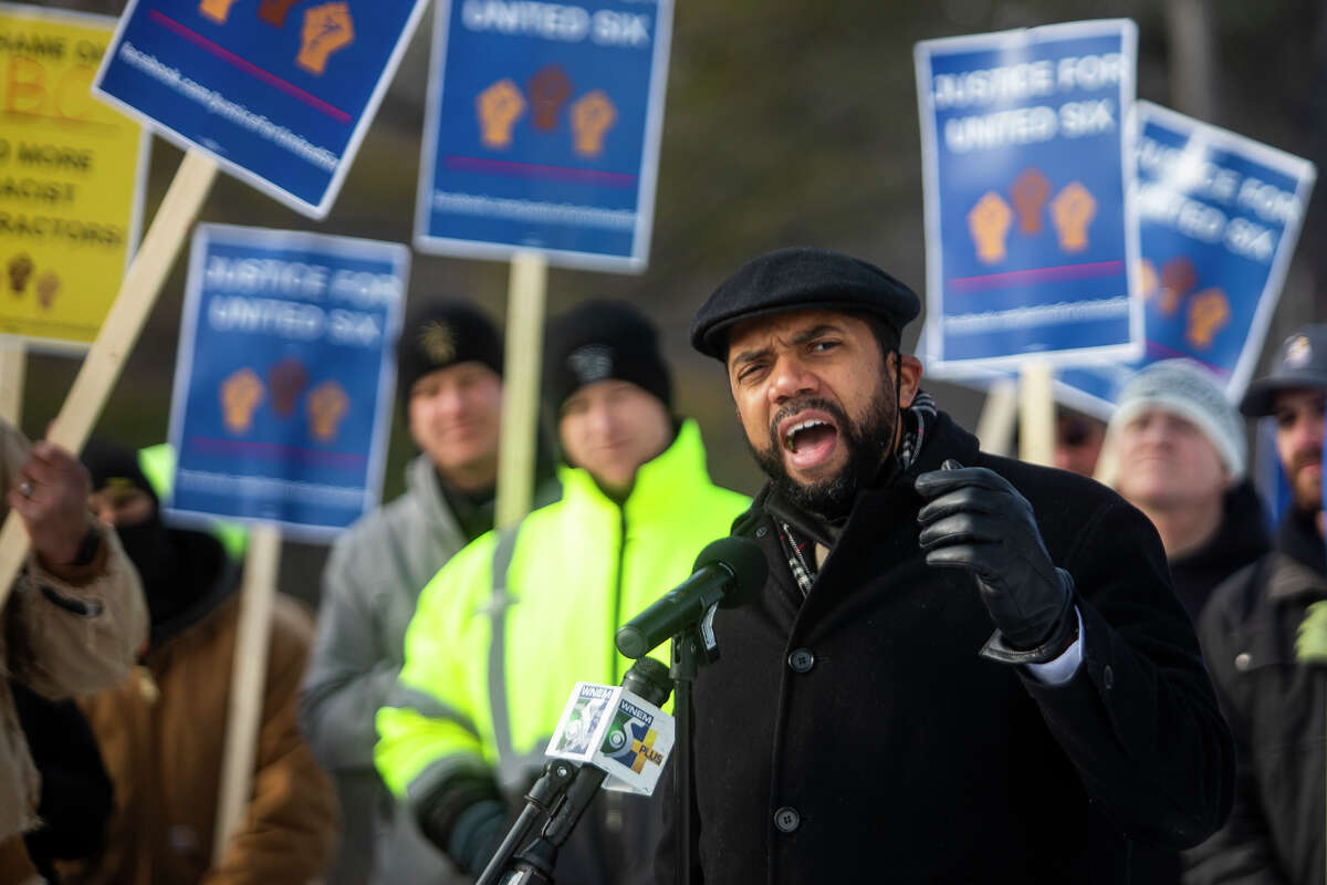 Richard Mack, an attorney hired to represent six former workers of United Electrical Contractors who have filed a lawsuit alleging racist treatment on job sites, speaks during a rally Tuesday, Feb. 1, 2022 outside of the Associated Builders and Contractors Greater Michigan Chapter in Midland.