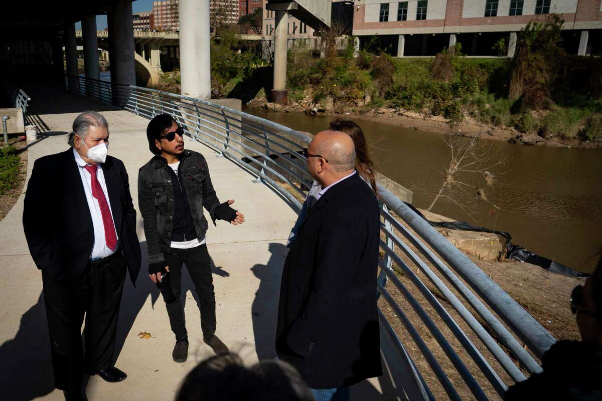 Richard Molina, center, talks about the site of his uncle José “Joe” Campos Torres’ death, Friday, Jan. 28, 2022, along Buffalo Bayou in downtown Houston. Campos Torres was murdered by Houston police and dumped in Buffalo Bayou in 1977 near the spot of the planned memorial.