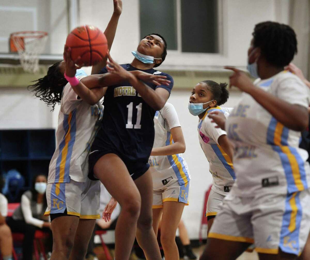 Notre Dame of Fairfield's Kayla Tilus is fouled as she drives to the basket amidst a crowd of Kolbe Cathedral defenders during their girls basketball game at the Sheehan Center in Bridgeport, Conn. on Friday, January 28, 2022.