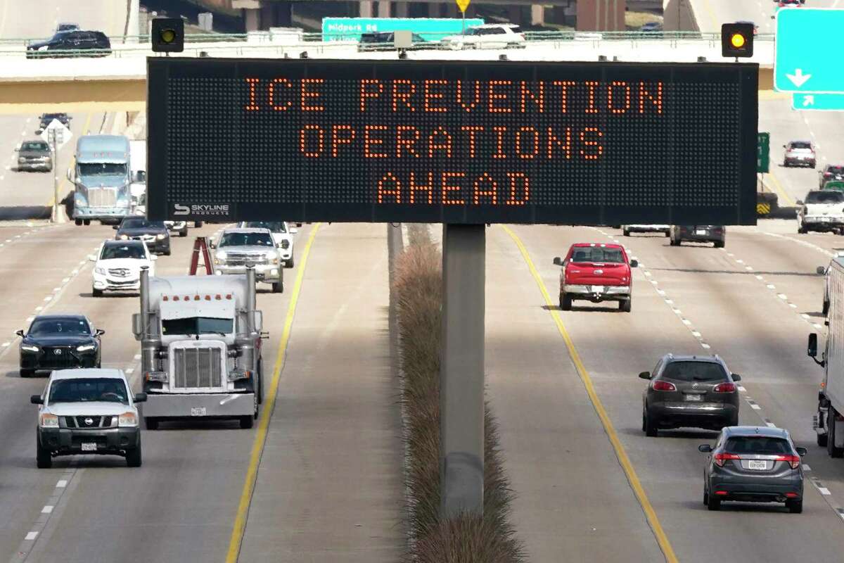 A street sign warns drivers Tuesday, Feb. 1, 2022, of ice prevention operations on highways ahead of winter weather in Dallas. A major winter storm was expected to affect a huge swath of the United States, with heavy snow starting in the Rockies and freezing rain as far south as Texas before it drops snow and ice on the Midwest. The forecast comes nearly a year after a catastrophic winter storm devastated Texas' power grid, causing hundreds of deaths.