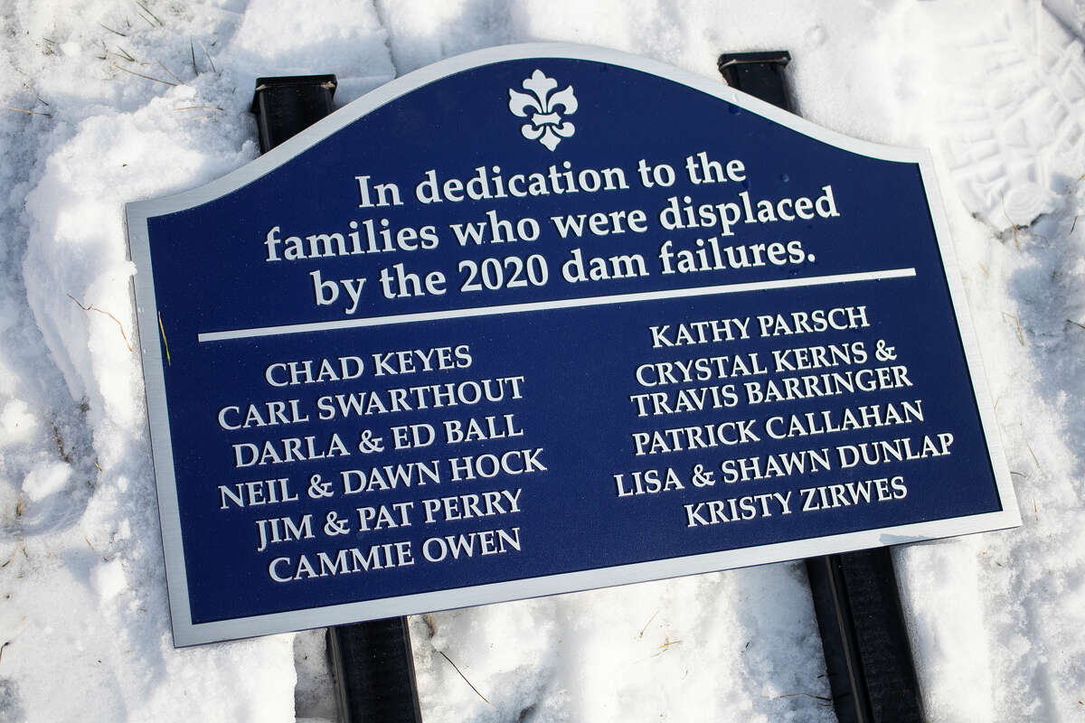 A new sign is placed in Porte Park Tuesday, Feb. 1, 2022, in honor of the families who were displaced by the 2020 dam failures.