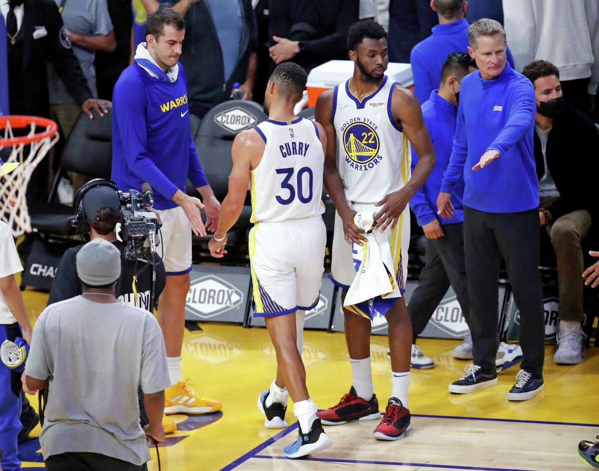 Golden State Warriors' Nemanja Bjelica, Stephen Curry, Andrew Wiggins and head coach Steve Kerr after Memphis Grizzlies' 104-101 win in overtime during NBA game at Chase Center in San Francisco, Calif., on Thursday, October 28, 2021.
