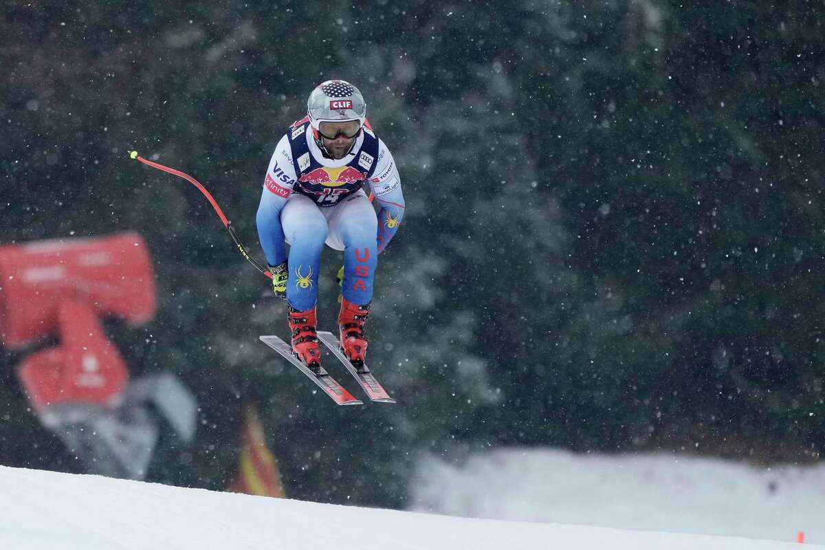 Travis Ganong of the United States speeds down the course during a men's Alpine Skiing World Cup downhill practice in Kitzbuehel, Austria, Thursday, Jan. 20, 2022. (AP Photo/Giovanni Auletta)