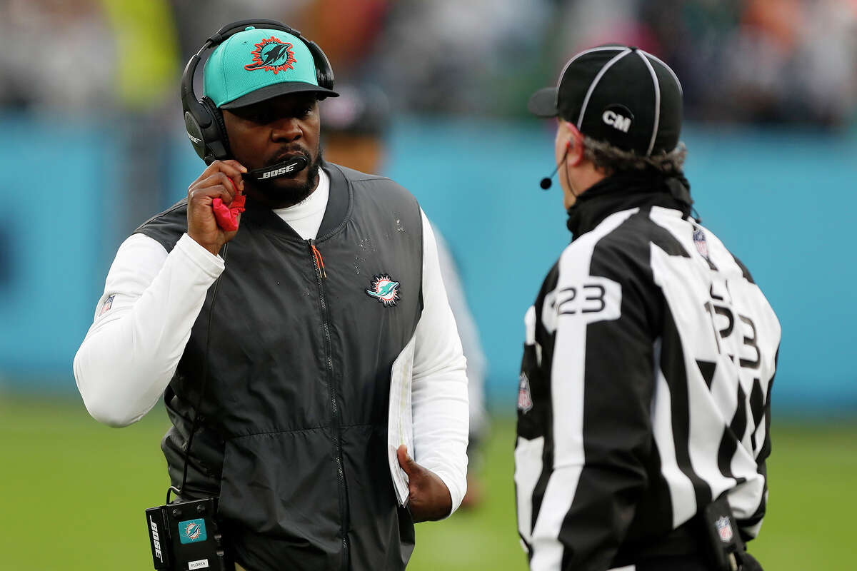 Head coach Brian Flores of the Miami Dolphins talks with line judge Mike Dolce (123) during the fourth quarter against the Tennessee Titans at Nissan Stadium on January 02, 2022, in Nashville, Tennessee.
