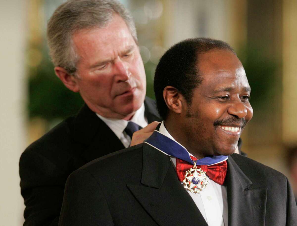 President Bush awards, Paul Rusesabagina, who sheltered people at a hotel he managed during the 1994 Rwandan genocide, the Presidential Medal of Freedom Award in the East Room of the White House, Wednesday, Nov. 9, 2005, in Washington. The Presidential Medal of Freedom is the highest civilian award given.(AP Photo/Lawrence Jackson)