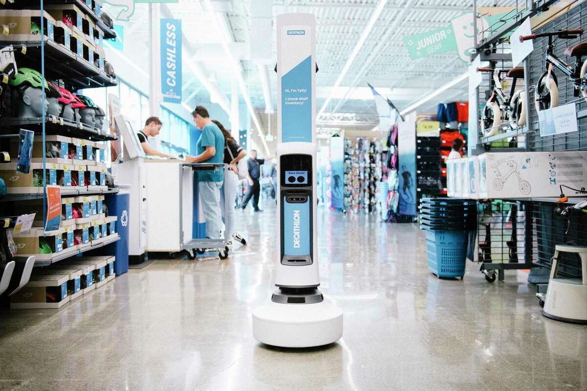 An inventory checking robot works it’s way down an aisle at Decathlon sports store in Emeryville, Calif., in 2019. Decathlon, the European affordable sports retailer is closing its stores in Emeryville and San Francisco.