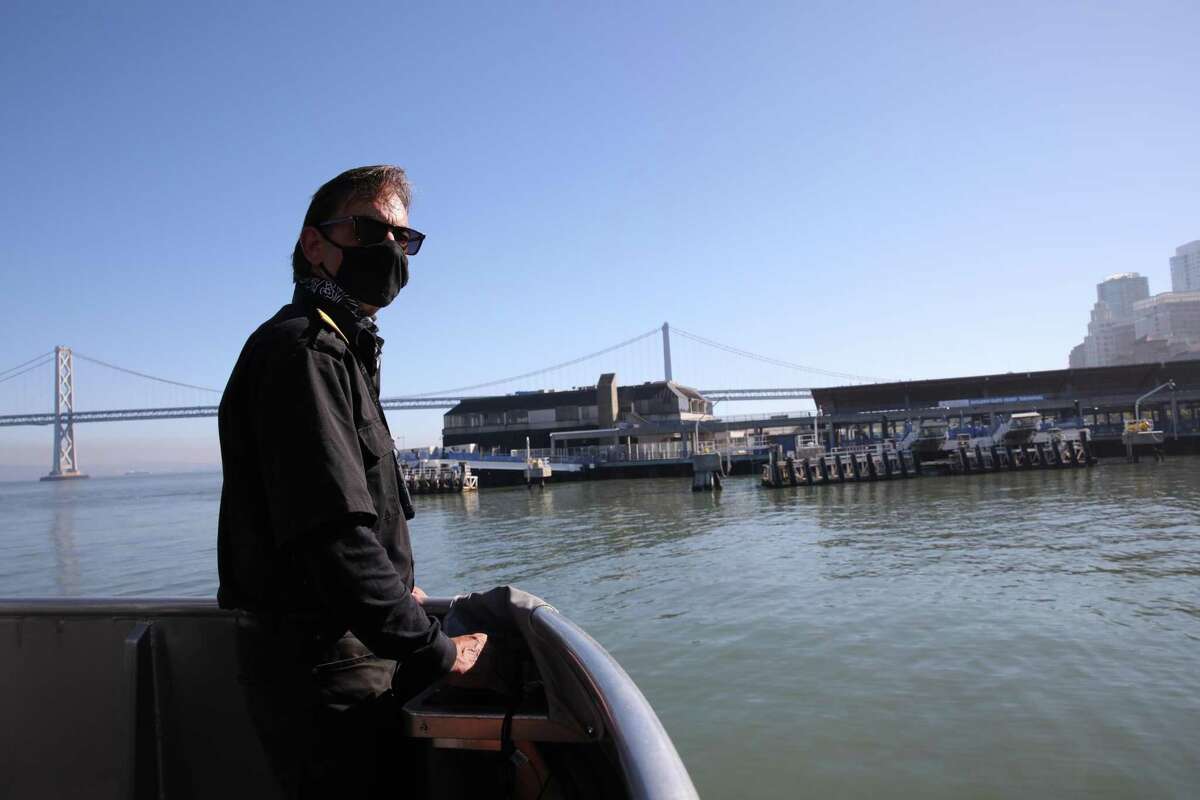 Ferry boat captain Ray Duran carries passengers from a trip to Treasure Island back to San Francisco in November. The service is expected to open to the public in March.