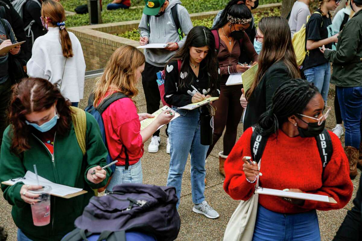 Texas State University students sign a petition to put cannabis decriminalization on the November ballot for San Marcos residents on the Quad in San Marcos, Texas, Tuesday afternoon, Feb. 1, 2022. Mano Amiga, an organization that fights for criminal justice and immigration reform, will be working to collect at least 4,400 signatures from San Marcos residents.