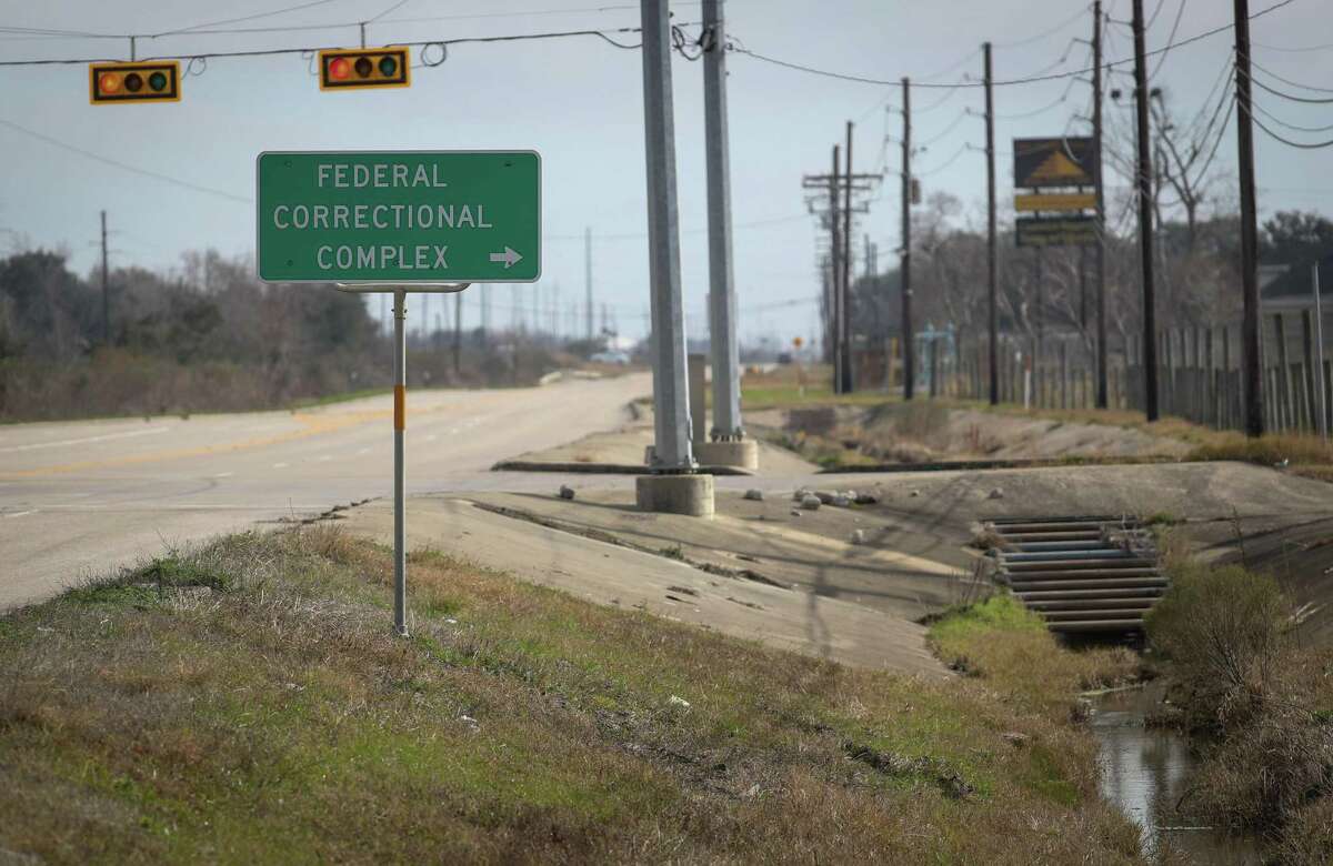 A sign at the intersection of Knauth Road and West Port Arthur Road directs people towards the federal prison complex where U.S. Penitentiary Beaumont is located, Tuesday, Feb. 1, 2022, in Beaumont.