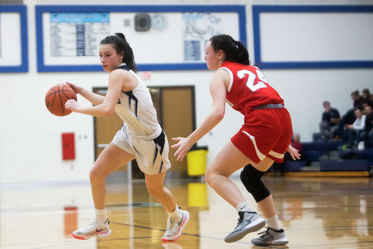 Meridian's Taylor Hopkins dribbles down the court while Beaverton's Taylor McCormack guards her during their game Tuesday, Feb. 1, 2022 at Meridian Early College High School.