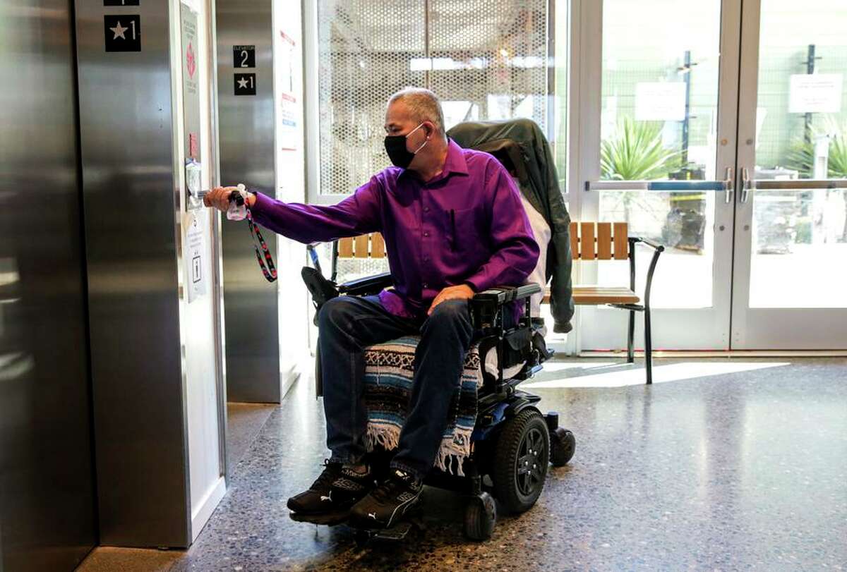 Resident Timothy Isaiah, 57, uses the elevator to get to his studio apartment in the new residence called Tahanan for formerly homeless people on Bryant Street in San Francisco.