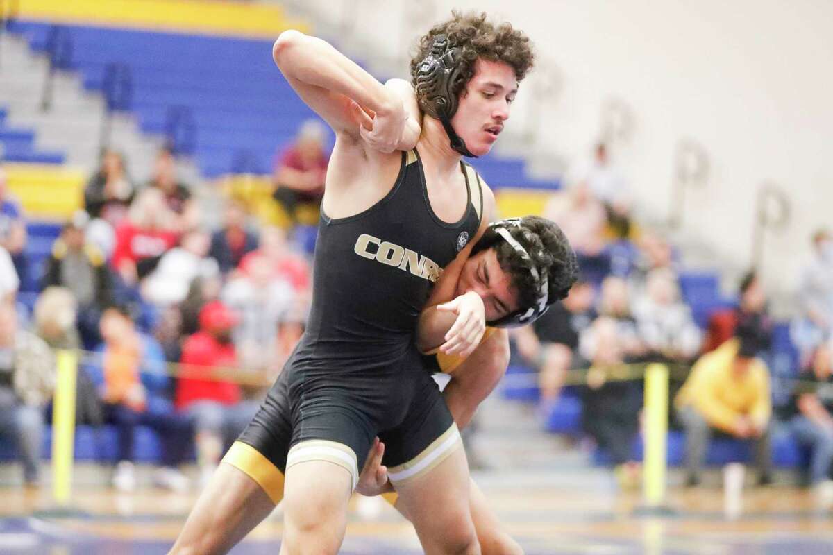 Adam Tuico of Conroe competes in a 126-pound bout against Diego Mas Rodrigue of Klein Oak during the District 8-6A wrestling championships at Klein High School, Tuesday, Feb. 1, 2022, in Spring.