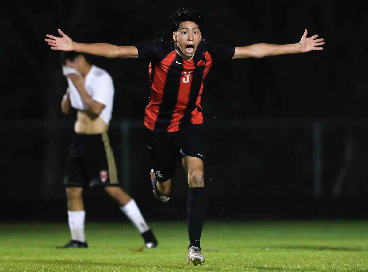 Porter’s Luis Marquez (9) reacts after scoring the game-tying goal during the second period of a high school soccer match at Porter High School, Tuesday, Feb. 1, 2022, in Porter. Marquez scored both of the Spartans’ goals in the team’s 2-1 win over Caney Creek.