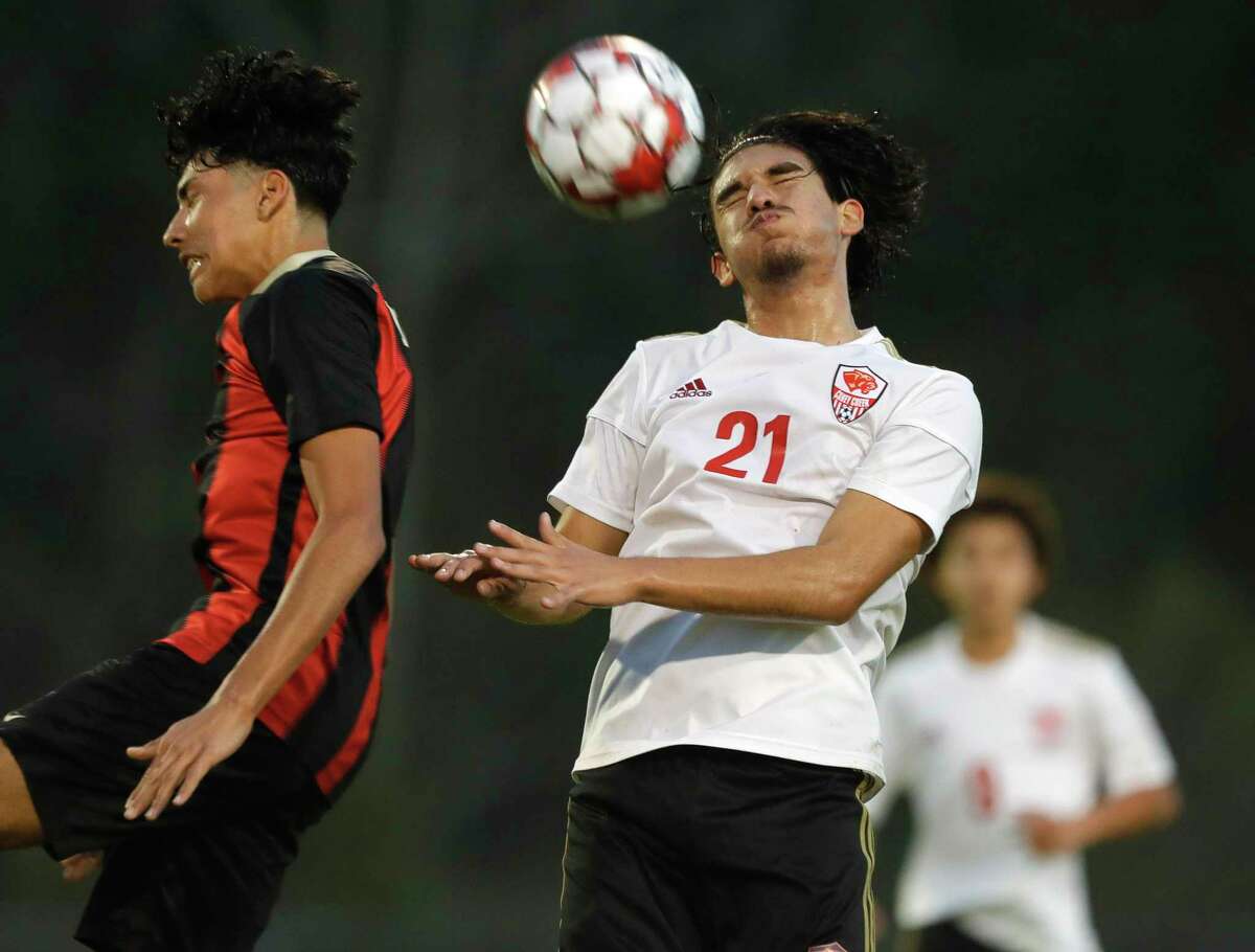 Caney Creek’s Mario Leon (21) heads the ball during the first period of a high school soccer match at Porter High School, Tuesday, Feb. 1, 2022, in Porter.