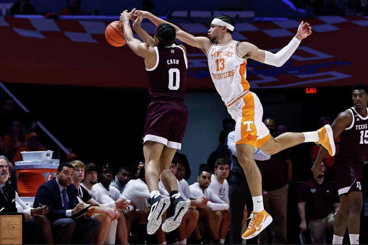 Tennessee forward Olivier Nkamhoua (13) knocks the ball away from Texas A&M guard Aaron Cash (0) during the second half Tuesday, Feb. 1, 2022, in Knoxville, Tenn.