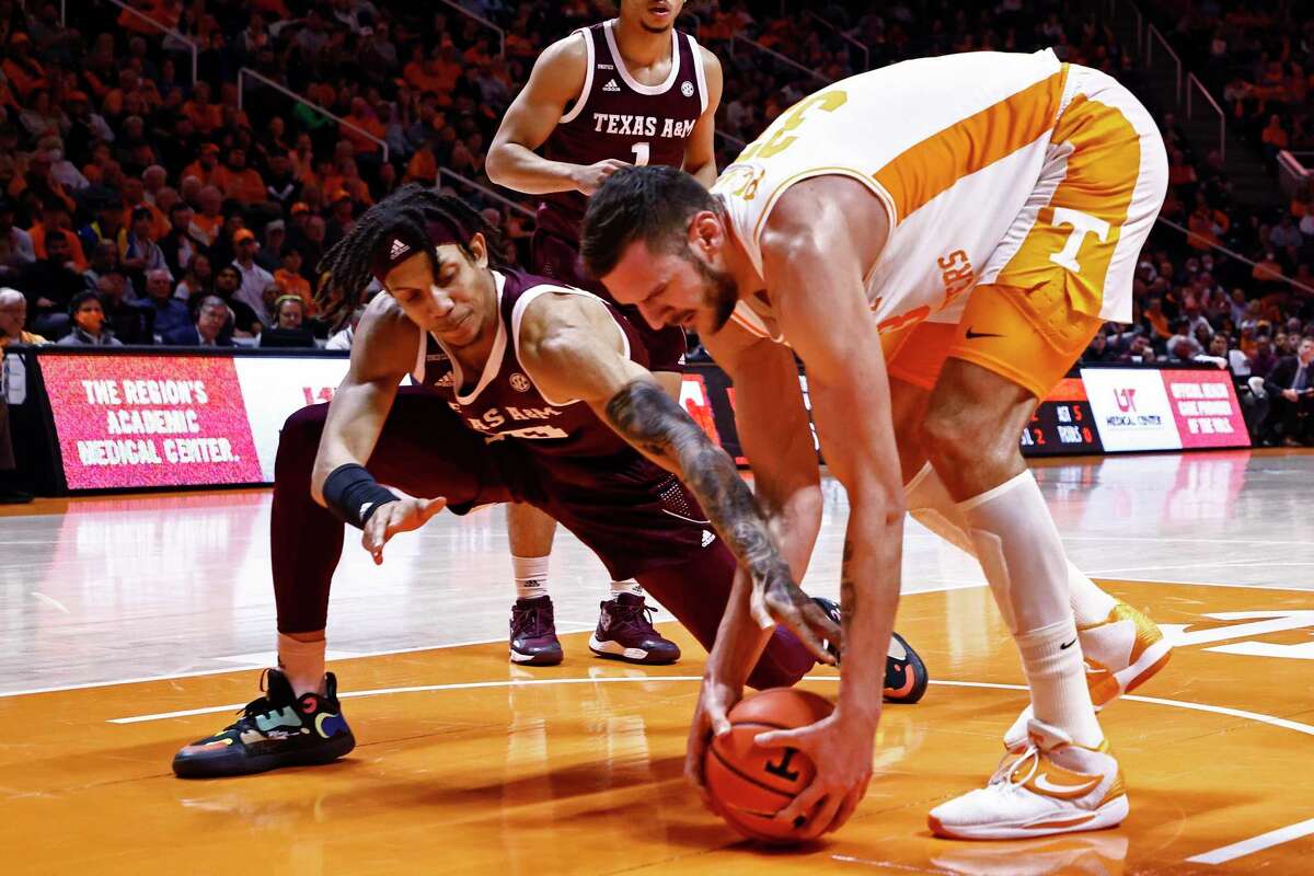 Texas A&M forward Ethan Henderson, left, vies for the ball against Tennessee forward Uros Plavsic during the second half Tuesday, Feb. 1, 2022, in Knoxville, Tenn. Tennessee won 90-80.