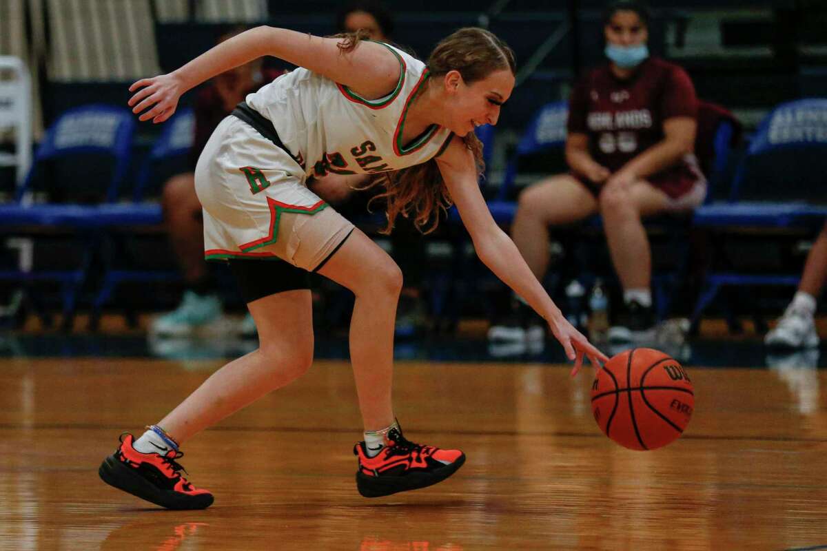 Sam Houston's Carmen Hansen (21) grabs the ball after forcing a Highland Owls turnover during the fourth quarter at Lanier High School in San Antonio, Texas, Tuesday, Feb. 1, 2022.