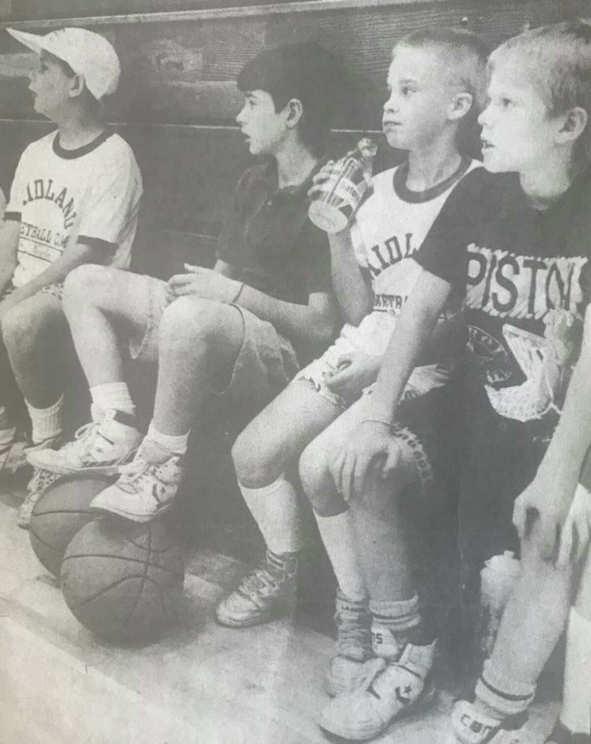Matt Levandoski rests his feet on a basketball while listening to instructions. Others are, from left, Justin Noyle, Nathan Thomas and Sean Parkhurst. July 1990