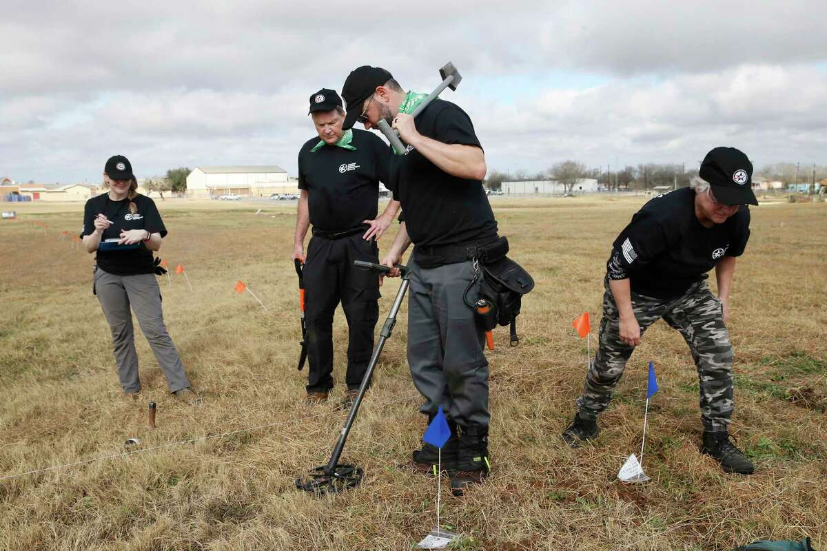 From left, Megan Lukaszeski, of New York, Tom Kane, of Boston, Jeremy Scroggins of Burleson, and Kathy Kuzmick of New Hampshire, work an area behind Losoya Middle School Tuesday searching for the remnants of the Battle of Medina.