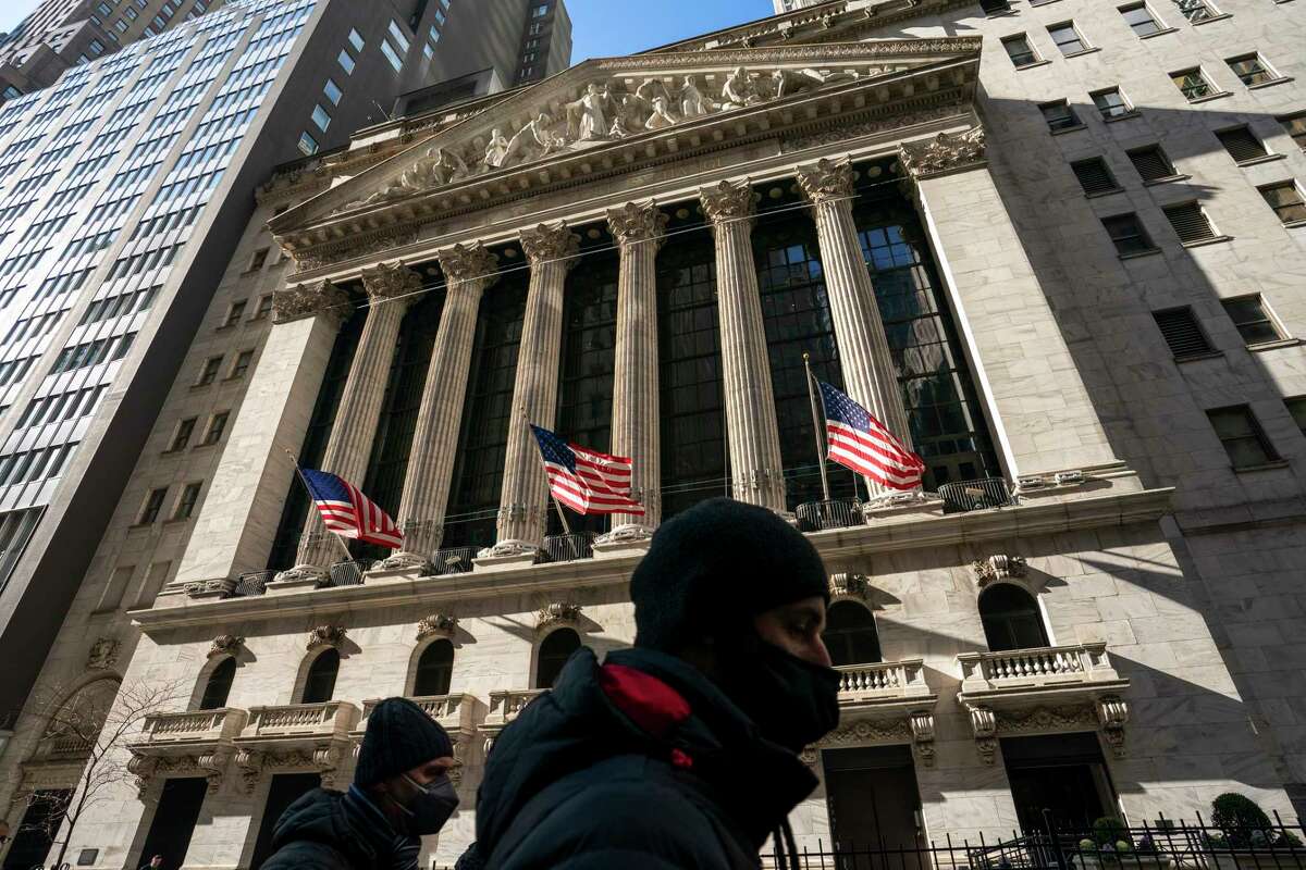 FILE - A pedestrian passes the New York Stock Exchange, Monday, Jan. 24, 2022, in New York. Stocks edged higher in morning trading on Wall Street Wednesday, Feb. 2, putting major indexes on track to extend their weekly gains.