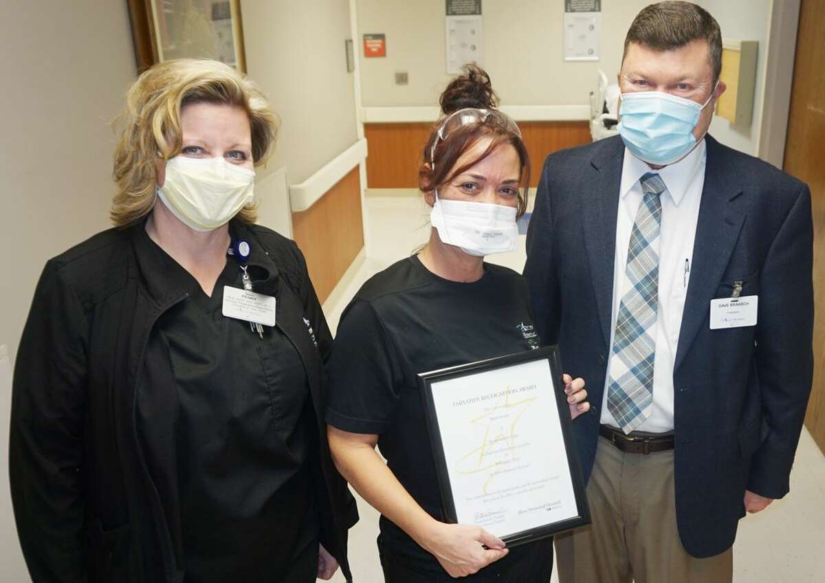 Barb Evans, center, of Alton Memorial Hospital’s Respiratory Therapy department is the AMH February Employee of the Month. She received the award Tuesday from her manager, Penny Krause, left, and AMH President Dave Braasch. 
