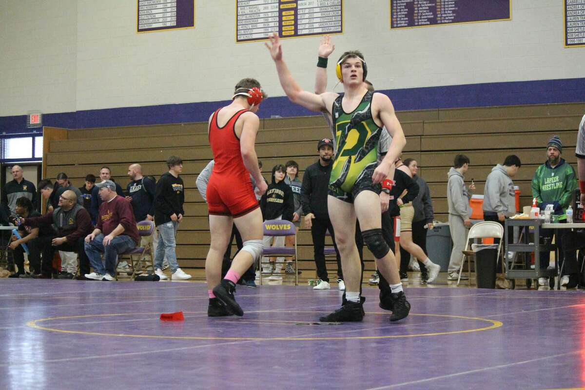 Dow High's Aidan Wardell waves to fans after winning a match at the Saginaw Valley League meet last Saturday, Jan. 29, 2022 in Bay City.