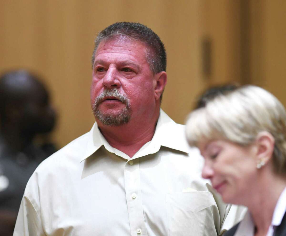 Former Stamford police officer Mark Ligi is arraigned and accompanied by his attorney, Sharen Friday, for a first-degree larceny charge at the Connecticut Superior Court in Stamford, Conn. Monday, June 24, 2019. Former Stamford police officers Chris Broems, Mark Ligi, Paul Pavia and Dave Sileo were arraigned Monday on first-degree larceny charges for allegedly submitting 643 false payroll vouchers totaling $187,618.