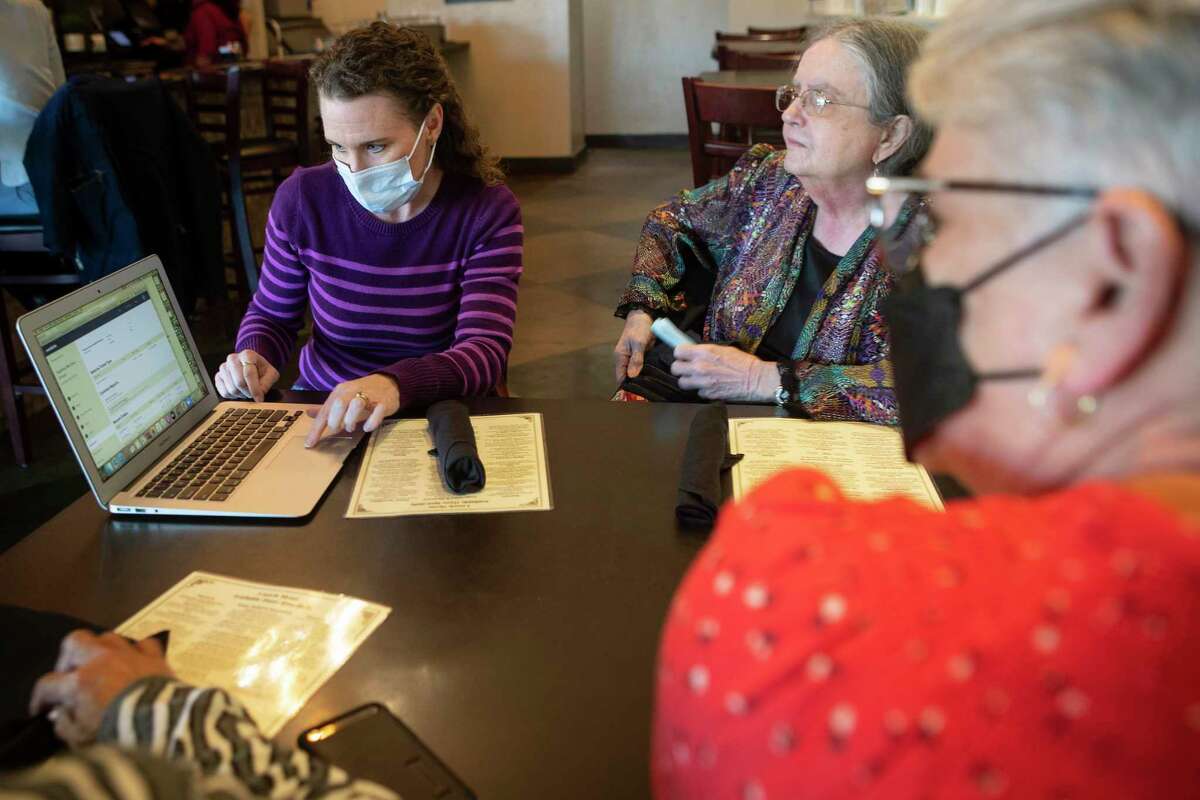 Diane Hunt, left, Nancy Agafitel and Linda Barry, of Spring Interfaith Council, meet at Hasta La Pasta while preparing a "Together We Dine -- Virtual" event Thursday, Jan. 13, 2022 in Houston. The group used to have in-person dialogue dinners, 70-80 people would gather for conversation about important topics around a dinner table, that was impossible during the pandemic.