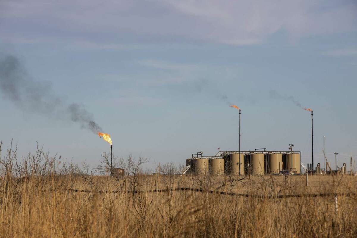 Flares burn off excess natural gas near Midland, Texas, on Saturday, Jan. 29, 2022. 