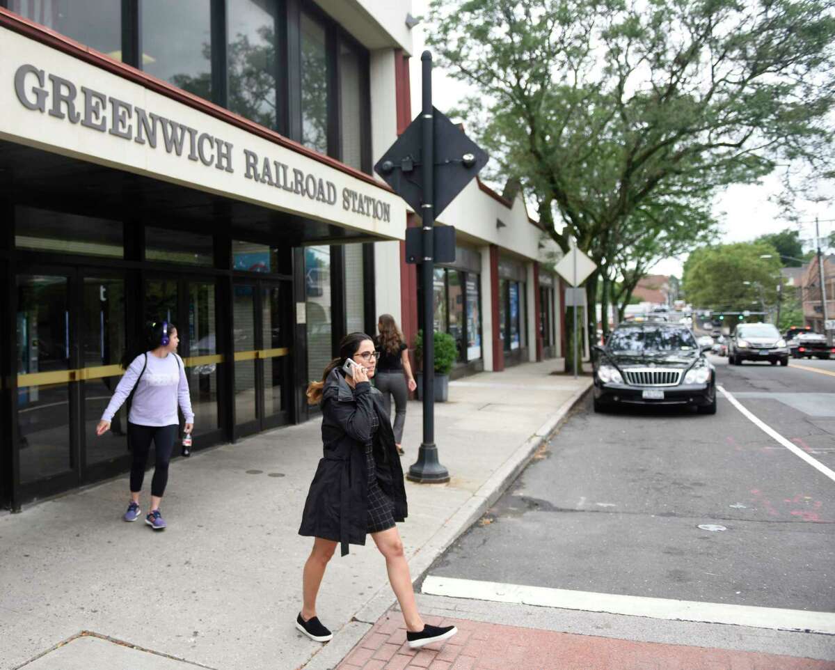 Commuters enter and exit the Greenwich Train Station in downtown Greenwich, Conn. Tuesday, July 23, 2019. The town is working with The Ashforth Company and Beyer Blinder Belle architects in a $45 million project to completely redevelop the central train station.