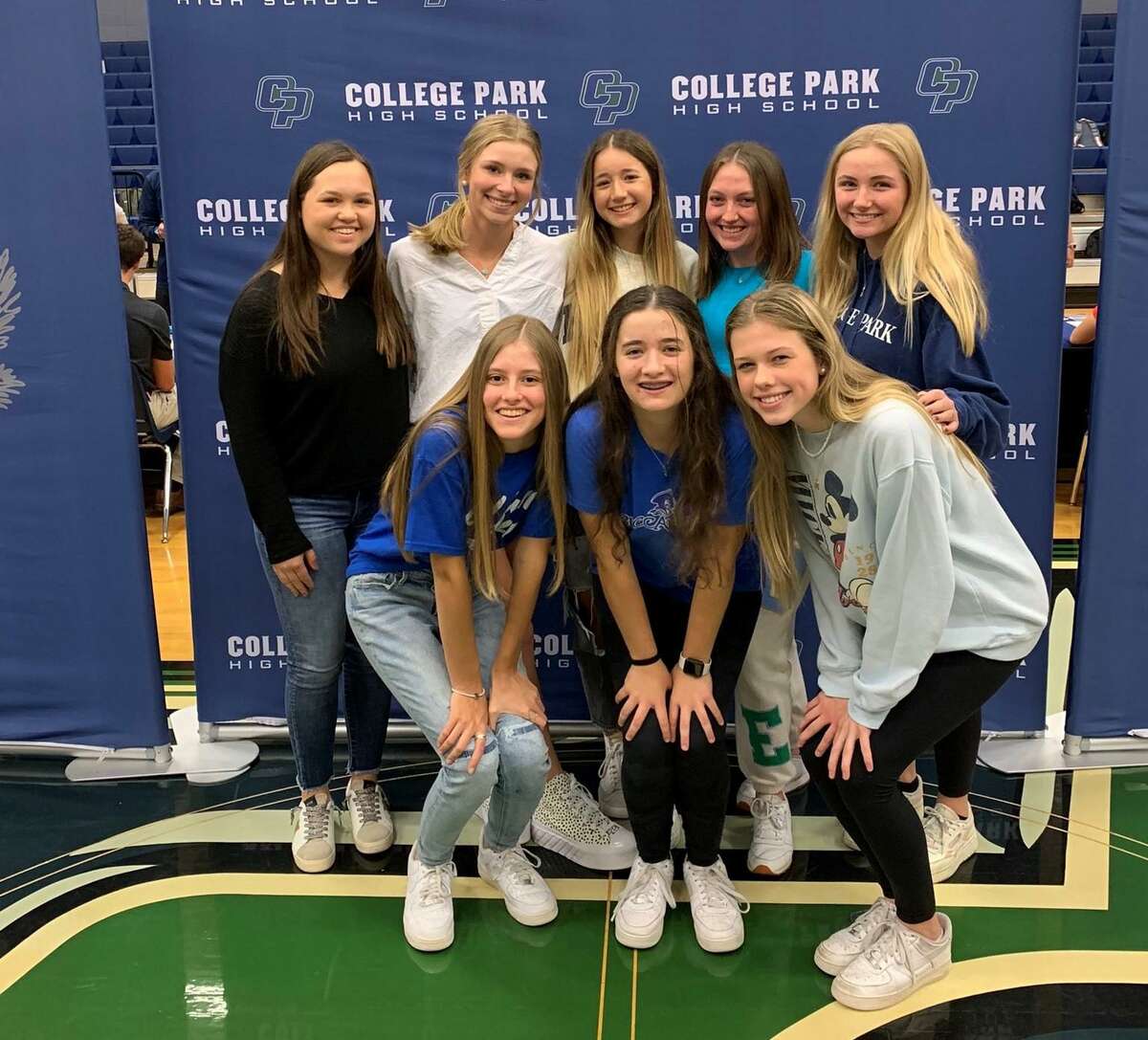 College Park golfer Emily Madeley poses for a photo with her teammates after signing with Blinn College on Wednesday Feb. 2, 2022.