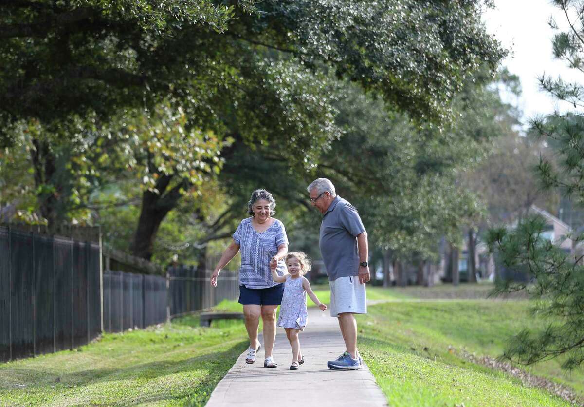 Al Cisneros and his wife Diana walk with their granddaughter, Caterina, 3, in their neighborhood, Friday, Dec. 17, 2021 in Tomball. Story is about the Diabetes Prevention Program, created by the CDC and offered locally by company First Mile. Cisneros joined the program after his doctor recommended it, and began making smart choices to get healthy and stave off his pre-diabetes diagnosis.
