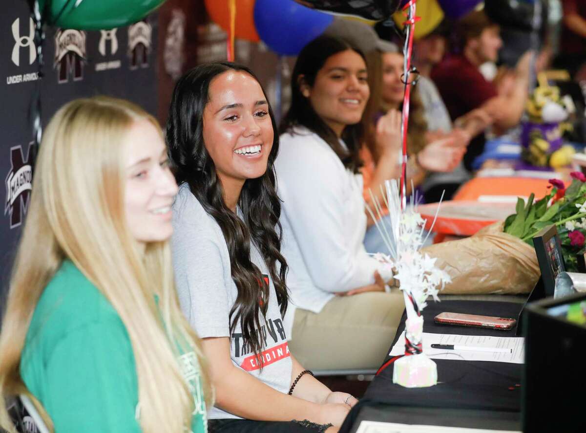 Krystal Anne Castaneda, second from right, signed to play softball for Trinity Valley as she joined nine other athletes who will play sports at the college level during a National Signing Day ceremony at Magnolia High School, Wednesday, Feb. 2, 2022.