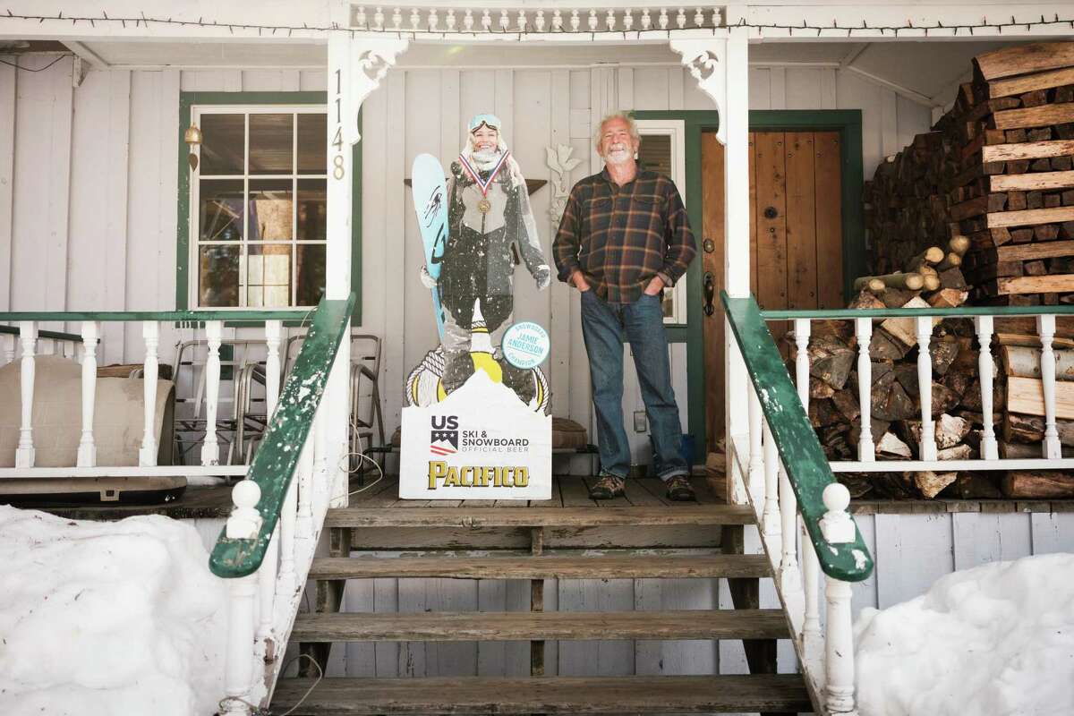 Joe Anderson poses for a portrait with a cardboard cutout of his daughter, Jamie Anderson, at his home in Meyers, California on Jan. 31. Anderson stayed behind to protect his home during last year’s Caldor Fire.