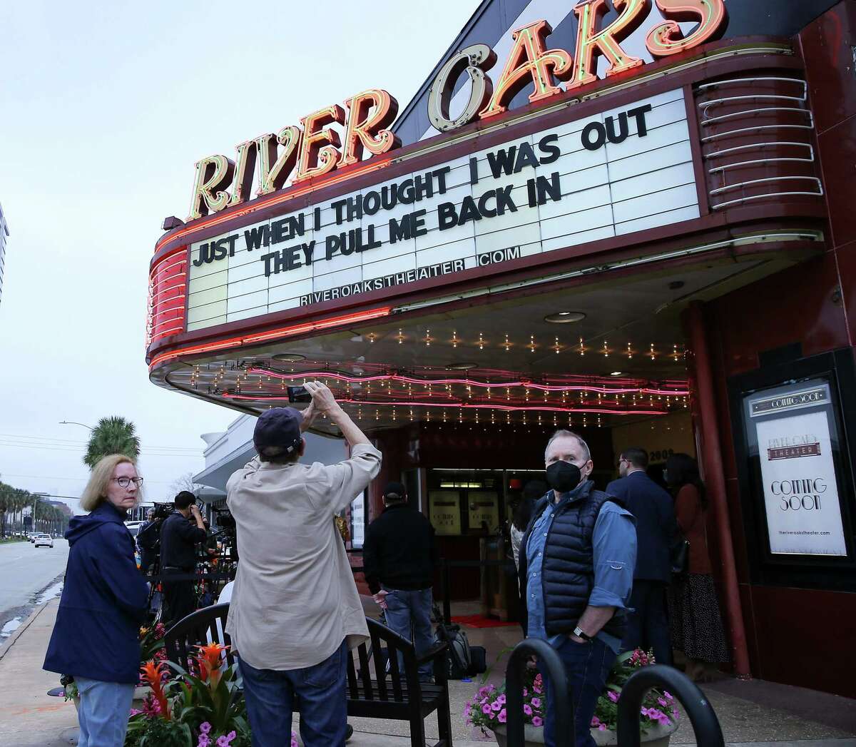 Media and attendees gather around the River Oaks Theater during a press conference announcing the small movie theater reopening in Houston on Wednesday, Feb. 2, 2022.